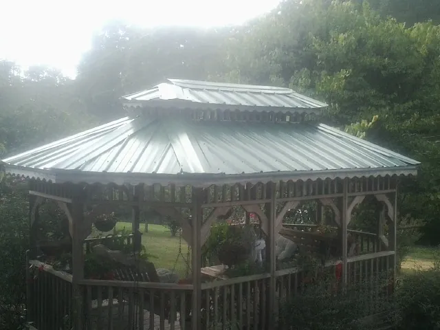 Two tier green metal roof on a garden gazebo in Buckingham